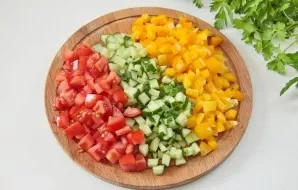 Cucumber, tomato and pepper cut into cubes of equal size.