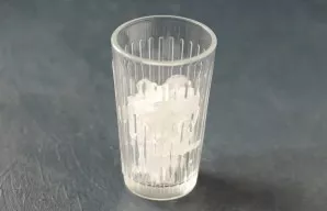 Pour the syrup into the bottom of the glass. Then add ice.