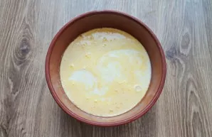 Pour milk into the beaten eggs.