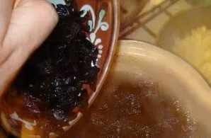 An hour after you start cooking the meat in a saucepan, add the onion and tomato, prunes and washed rice. 15 minutes before preparation, ...