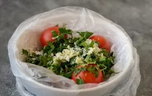 Put cherry tomatoes, salt, herbs and garlic in a bag.