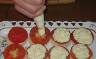 Put a tablespoon or two of the cheese mixture on top of the tomatoes.