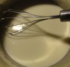 While continuing to beat, add milk in a thin stream.