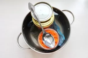 Put a clean cloth in the pot and place the jars on it so that they do not touch. Pour warm water and cover with lids. Bring to a boil ove...