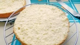 Cool the prepared biscuit and cut it into two halves.