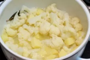 Add cauliflower and cook until the potatoes are tender.