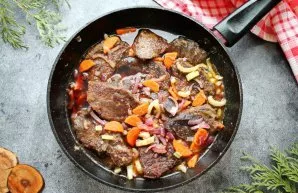 Pour red wine into the pan, add salt and pepper. Simmer for another minute.