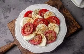 Sprinkle dried oregano, salt and black pepper on top.