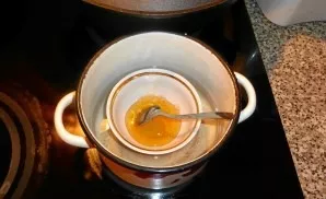 Dissolve honey in a water bath.