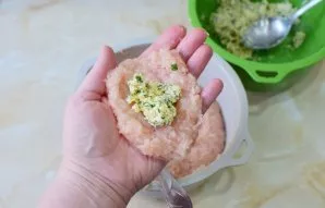 For the cutlet, take the meat and put the cheese filling in the center. Make a cutlet so that the filling remains inside. Roll the cutlet...