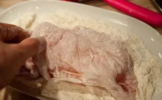 Roll the breasts in flour.