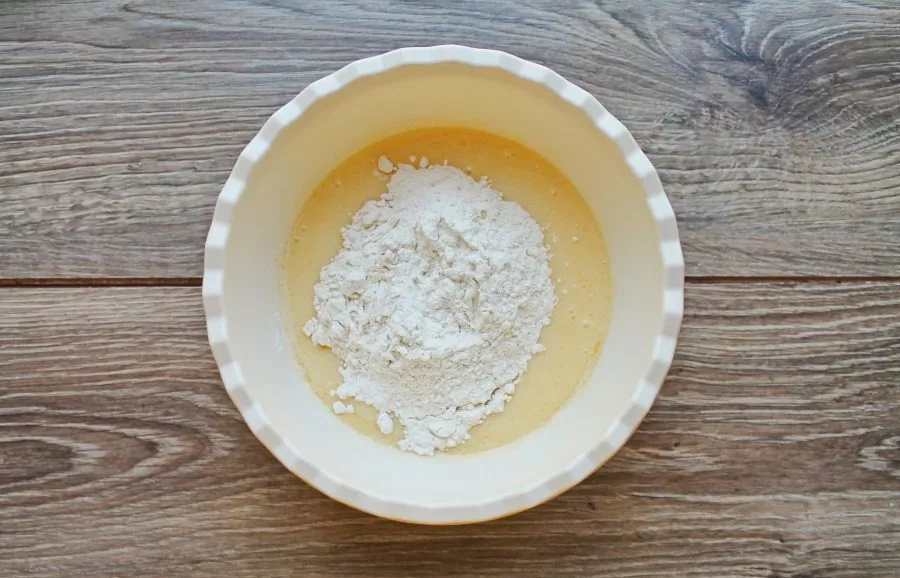 Mix flour with baking powder and sift into a bowl. Mix until smooth, it should be like thick sour cream.