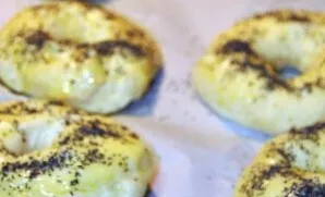 Line the baking sheet with baking paper. Put boiled buns on it and sprinkle with sesame seeds and poppy seeds. Preheat the oven to 180 de...