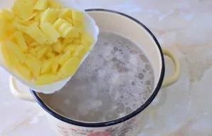 Bring the broth to a boil and return the meat to it. Peel the potatoes, cut into pieces and put in boiling broth. Leave to boil for 15 mi...