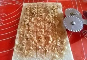 Sprinkle cinnamon sugar and nuts on top. Make 4 longitudinal cuts.