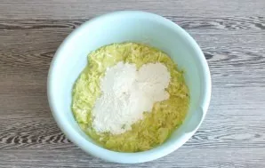 Add flour. Depending on the amount of zucchini, you may need a little more.