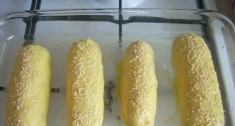 Grease any convenient baking dish with softened butter. Beat the egg with a fork. We put the sausages in the dough in a mold, brush with ...