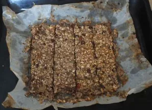 After the time has elapsed, remove the bars from the oven, cool slightly and cut into portions. After that, without removing the baking p...