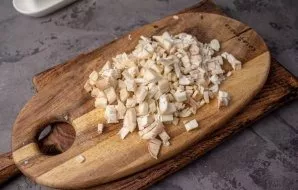 While the vegetables are cooking, finely chop the stems of the mushrooms.