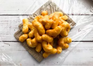 Place corn sticks on top of the cling film.