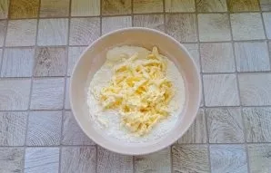 In a bowl with dry ingredients, grate cold butter.