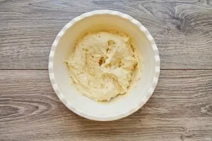 Mix flour with baking powder and sift into a bowl with whipped mass. Mix everything until smooth and soft dough.