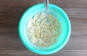 Start kneading the dough with a fork.