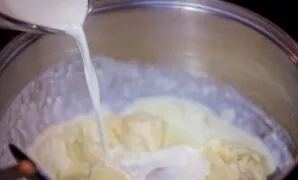 Gradually pour in the cream and continue to stir.