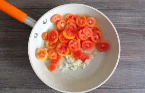 Heat 30 ml in a pan. vegetable oil. Transfer the tomatoes and garlic to it. Cook for 3-4 minutes, stirring constantly.