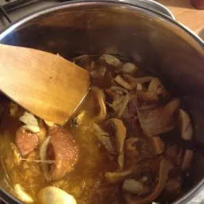 Then add mushrooms, onions, garlic. Cover with a lid and cook for another 30 minutes over low heat.