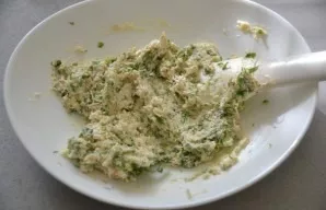 Add greens to the cheese and mix.