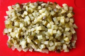 Finally, chop the pickled cucumbers. Mix all the crushed ingredients, add green peas, mayonnaise and salt to taste. Stir, garnish with he...