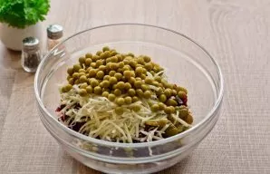 Next, add canned peas to the salad.