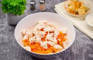 Cool the chicken fillet and cut into small cubes. Transfer the chicken to the salad.
