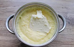 Add softened butter to the cooled cream and beat until smooth and fluffy.