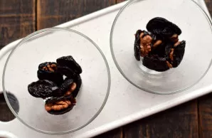 Prepare two small bowls. Place 5 pieces of plums and walnuts in the bottom of each.