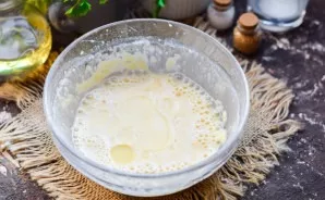 Beat the dough with a mixer. Add a couple of tablespoons of vegetable oil, mix.