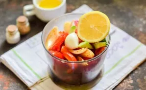 Then add a clove of garlic to the vegetables and squeeze lemon juice into it.