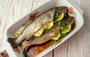 Remove the fish from the refrigerator, fill the belly with sprigs of parsley and slices of lemon. Put to bake in an oven preheated to 200...