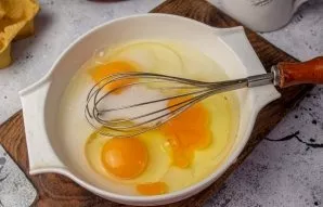 For the filling, mix the eggs with milk. Add salt and pepper.