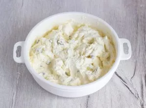 Pour the egg mixture into the cottage cheese and mix well again.