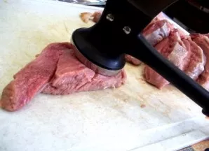 Wash the veal under running water and dry thoroughly with paper towels. Cut the meat into 1.5 cm wide portions and beat well.