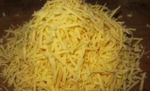 Sprinkle the almost finished chicken with grated cheese.