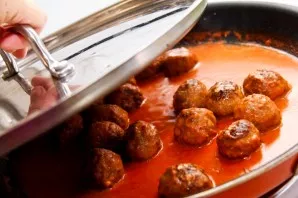 Cover with a lid and simmer the dumplings in tomato sauce until cooked over medium heat. Before serving, you can add chopped fresh herbs ...