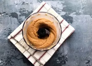 Continue to beat the peanuts until the mixture becomes a paste.