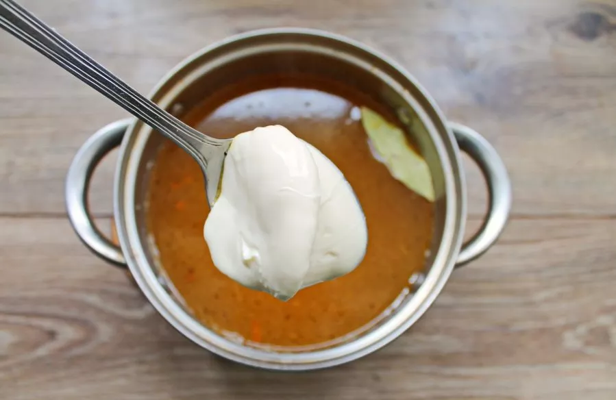 Add melted cheese to the soup, mix and cook for 5 minutes.