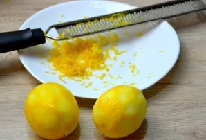 Grate the zest of two lemons.
