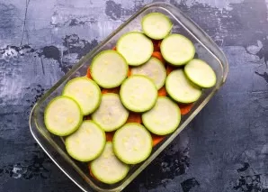 Lay out the sliced zucchini on top of the carrots.