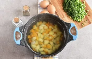 Add salt to the pot with potatoes and carrots.