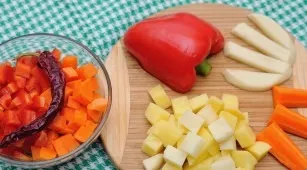 Wash the remaining vegetables, peel and cut into cubes. Put in a saucepan and continue to simmer, adding tomato paste and spices to taste.